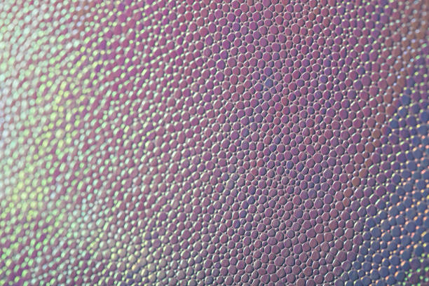 istock Abstract background with artificial leather shot close-up. Stock macro texture. Imitation of iridescent scales. 1307006549