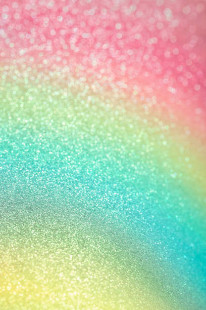 istock Sparkling glitter vertical background. Abstract texture of shiny grainy paper with gradient pink, green and yellow dusting 1307007085
