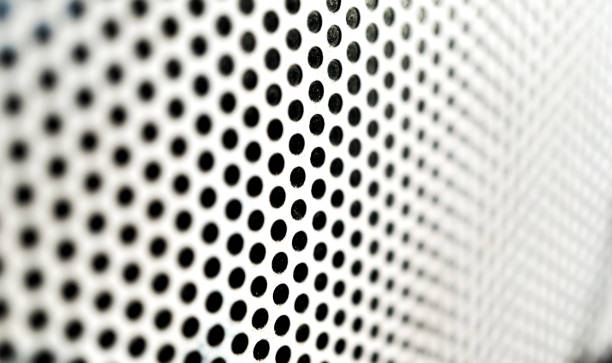 istock Background sheet of metal with circular holes 1307007236