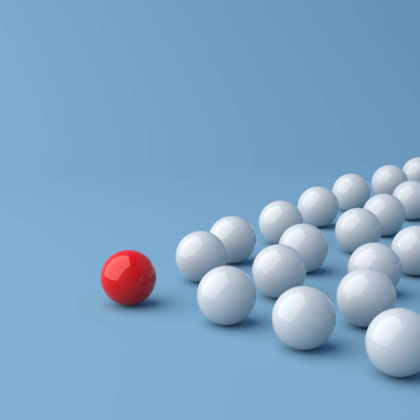 istock Leadership concept, red leader ball leading white balls, on blue background with empty copy space 1307007389