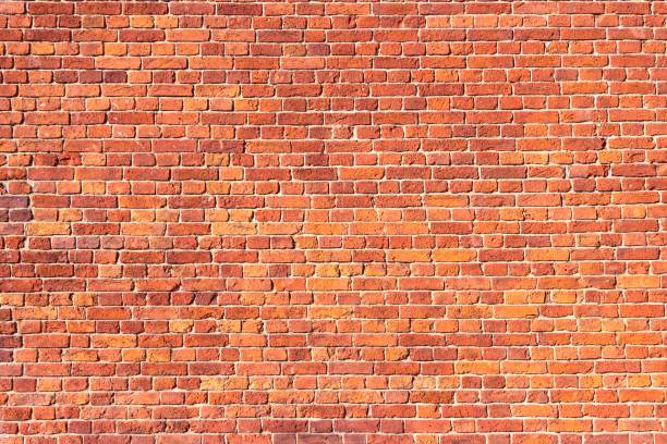 istock A wall of old, cracked bricks, with a weathered and faded surface. 1307008444