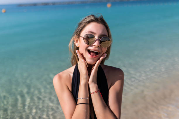 istock Beautiful young woman doing selfie on the beach 1307008951