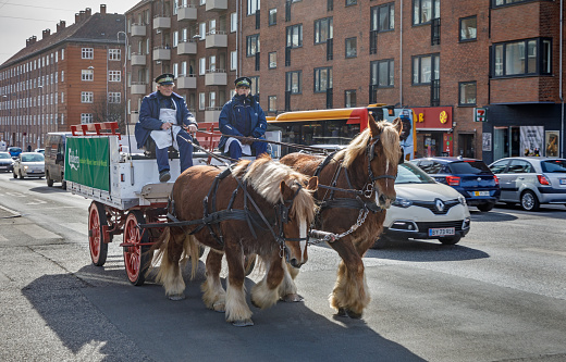 Horse driven carriage from the Carlsberg brewery in a street in Valby, a suburb to Copenhagen. This kind of carriages where a common sight in old days and a couple are still operating as an advertisement stunt