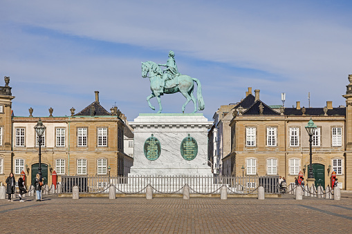 Copenhagen, Denmark - May 14, 2023: Amalienborg Palace, Equestrian statue Of Frederick V, People Walking, Taking Picture During Springtime In Scandinavia Northern Europe