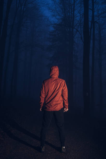 istock man stands motionless in a dark forest, trying to find himself thinking about his future. Feeling of emptiness, crampedness. The man is trying to fight his demons 1307012125