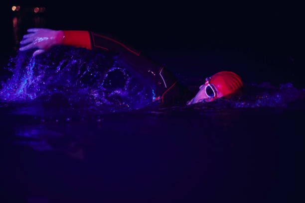 istock real triathlon athlete swimming in dark night 1307012396
