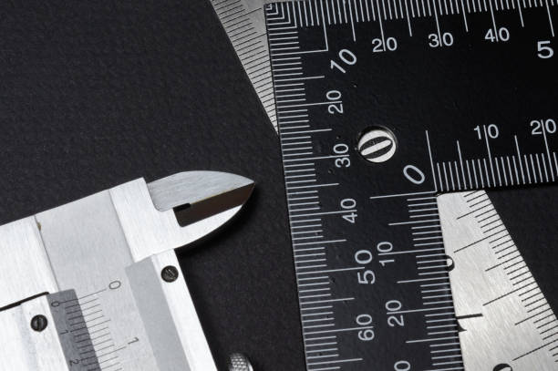 istock measuring tool, ruler square and caliper. lie on a dark background. close-up. 1307013058