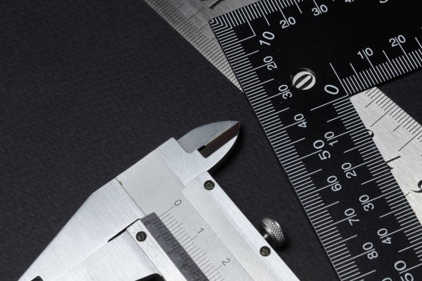 istock measuring tool, ruler square and caliper. lie on a dark background. close-up. 1307013118