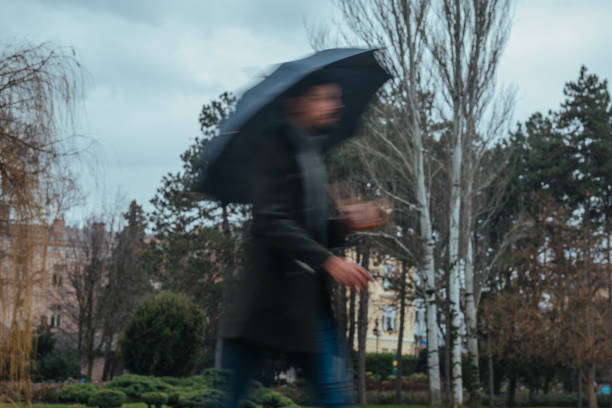 istock Businessman hurrying to work during rainy day 1307013350