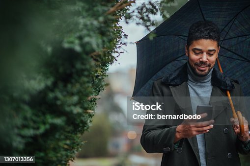 istock Young man using phone outdoors 1307013356