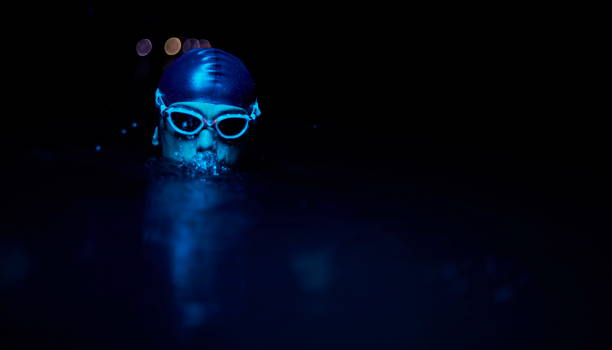 istock authentic triathlete swimmer having a break during hard training on night neon gel light 1307014732