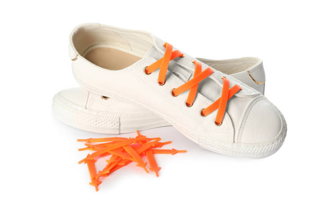 白い背景にオレンジシリコーンレースのスポーティな靴 - open collar ストックフォトと画像