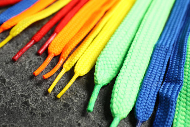 Heap of multicolored shoe laces. Pile of colorful strings for sport shoes isolated on white background.