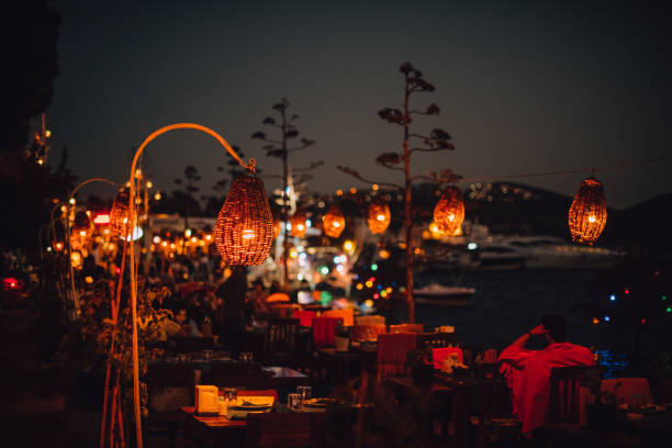 istock Seaside Restaurants With Colorful Lights on Summer Evening 1307016959