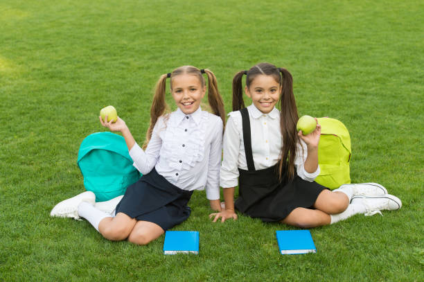 istock School friends relaxing after classes at school yard, lunch time concept 1307017209