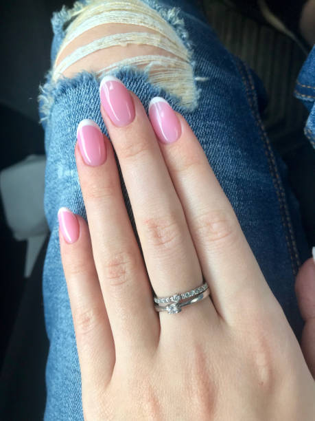 istock A graceful female hand with a beautiful pink manicure 1307018297