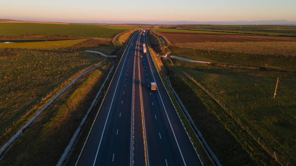 istock Drone image of a highway on a sunset 1307019526