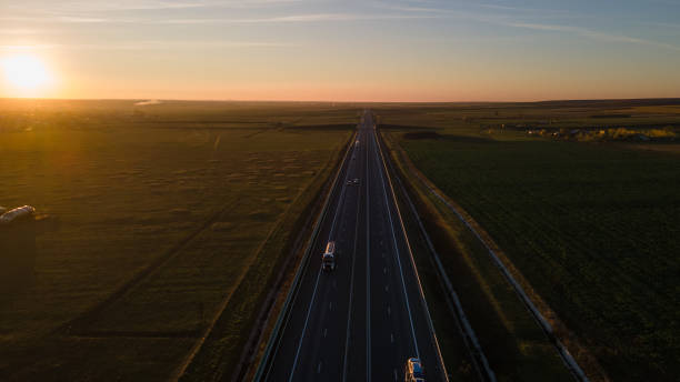 istock Drone image of a highway on a sunset 1307019537