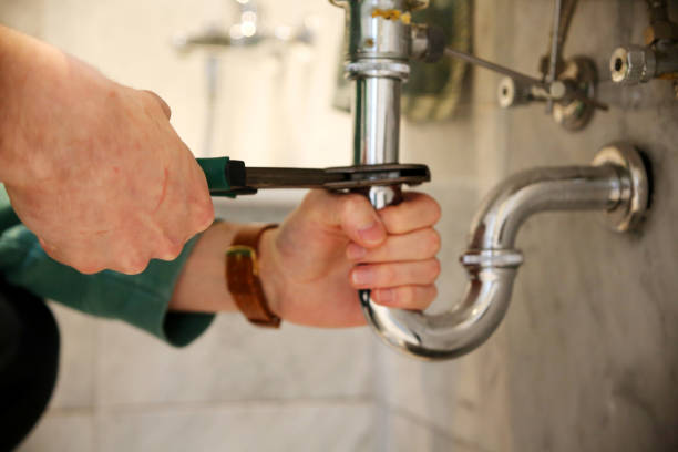 istock Plumber repairs a drain with pliers. 1307019970