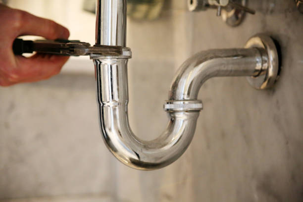 istock Plumber repairs a drain with pliers. 1307019994