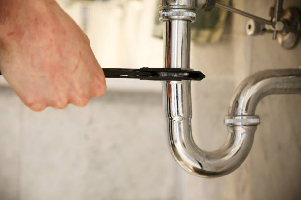 istock Plumber repairs a drain with pliers. 1307020717