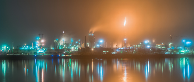 Industrial landscape with the river Rhine and chemical production plants at Ludwigshafen as seen from Mannheim in Germany.