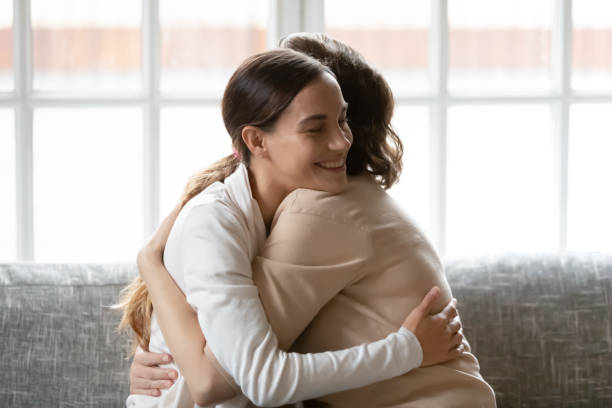 istock Close up affectionate grownup daughter hugging middle aged mother 1307021055