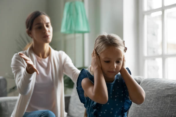 怒っている怒っている母親を無視して、耳を覆う動揺した小さな女の子を閉じる - daughter distraught little girls worried ストックフォトと画像