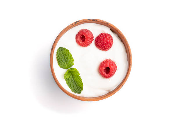 istock Yogurt with raspberry in clay cup isolated on white background. top view, flat lay, close up. 1307022345