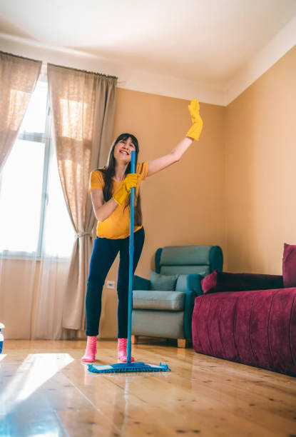 istock Woman having fun while cleaning home 1307023615