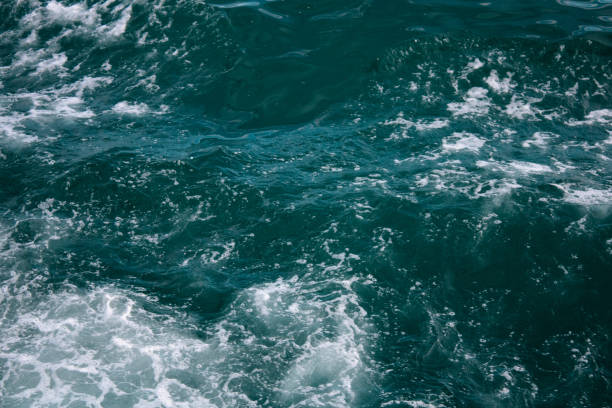 istock Abstract blue sea water with white wave for background 1307025567