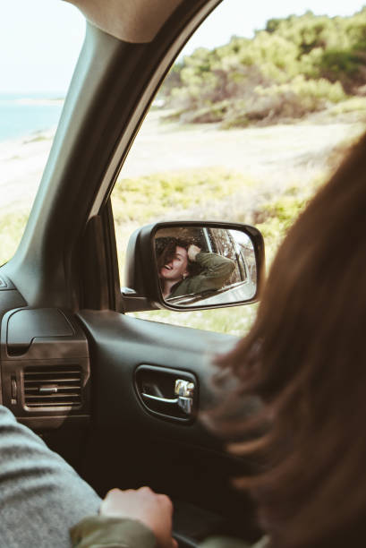 istock reflection on stunning smiling woman in car rear mirror 1307026673