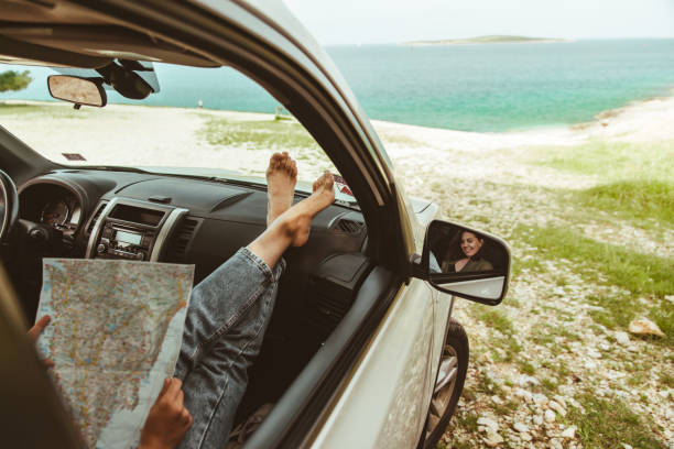 istock woman legs at car dashboard sea on background 1307026862