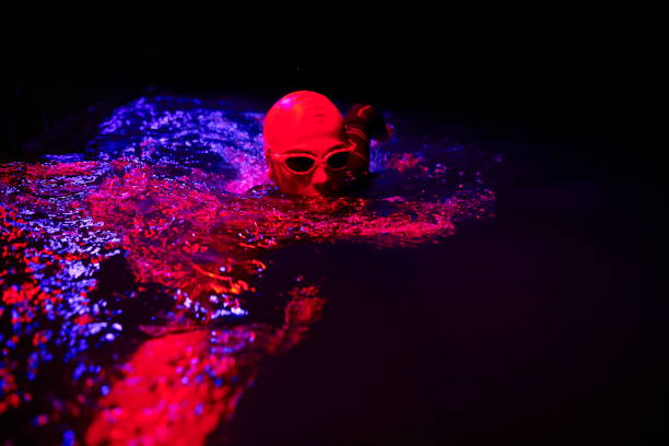 istock real triathlon athlete swimming in dark night 1307027826