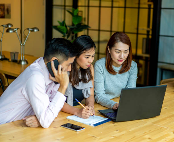 istock Asians Millennials discussing work in coworking space. 1307028969