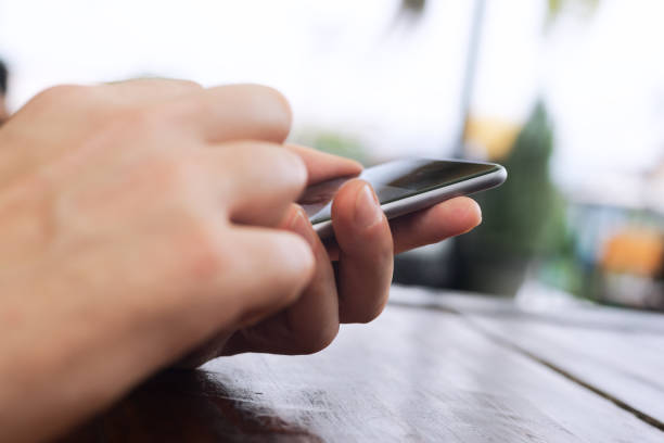 istock Mobile in male caucasian hands 1307029348