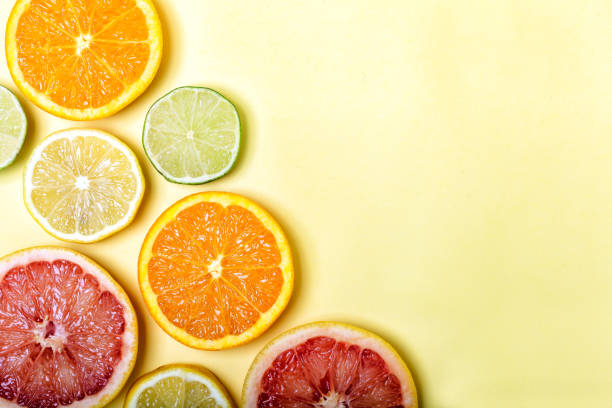 istock Many different citrus fruits on color background. 1307029504