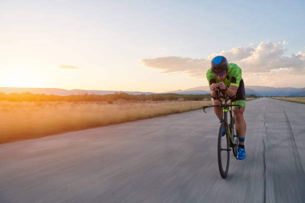 istock triathlon athlete riding a bike 1307030199
