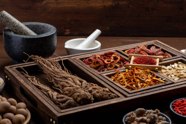 istock Ancient Chinese medicine books and herbs on the table 1307030766