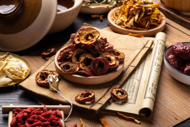 istock Ancient Chinese medicine books and herbs on the table 1307031617