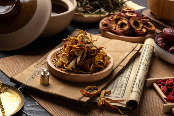 istock Ancient Chinese medicine books and herbs on the table 1307031958