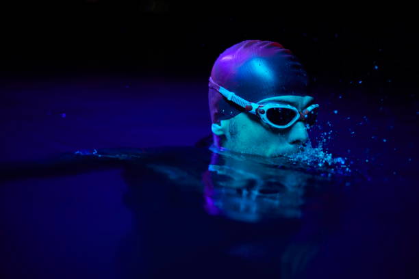 istock authentic triathlete swimmer having a break during hard training on night neon gel light 1307032030