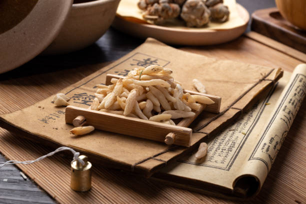 istock Ancient Chinese medicine books and herbs on the table 1307032191