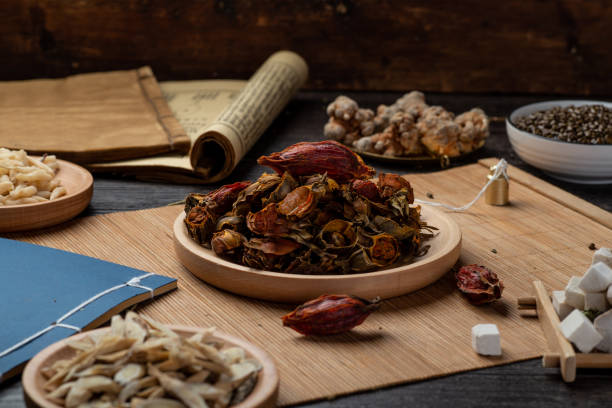 istock Ancient Chinese medicine books and herbs on the table 1307032206