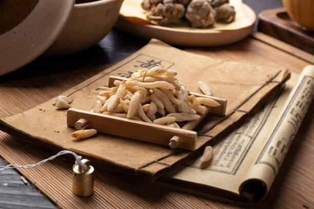 istock Ancient Chinese medicine books and herbs on the table 1307032219