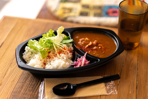 Takeaway meals from restaurants at home.\nEat bento delivered by Uber Eats at home.\nChickin curry. Salad. Rice\nDisposable spoon. Oshibori. Wet towel.