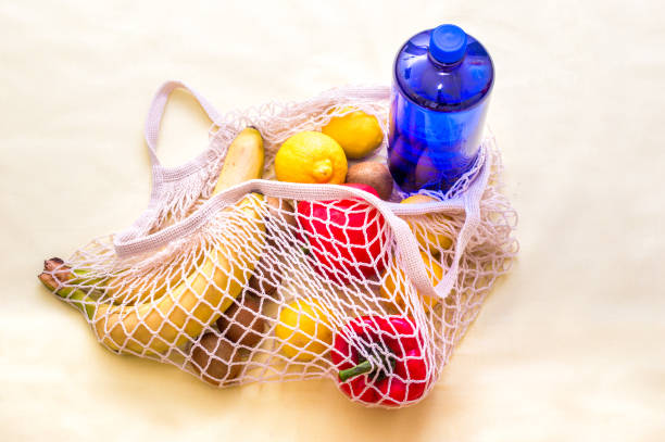 istock Eco bag with groceries on a yellow background. Plactic free concept 1307037618