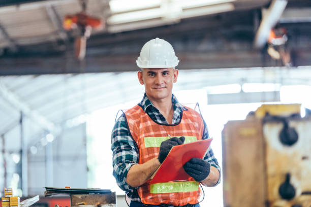 istock Portrait of engineer foreman in hardhat working on construction repair checklist document clipboard in industrial manufacturing factory. worker man in protective uniform work hard. copy space 1307038757