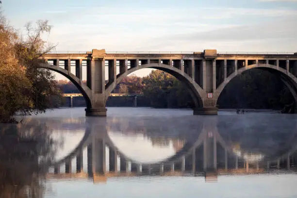 Constructed in 1925, the RF&P Railroad Bridge crosses over the Rappahannock River at Fredericksburg, Virginia. Seen here reflected against the Rappahannock River.