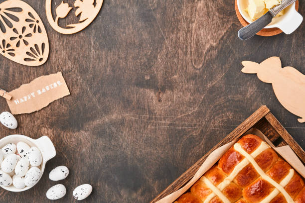 istock Easter Hot Cross Buns. Traditional breakfast and Easter baking holiday decorations rabbiton dark old wooden background. Bright colors, view from above on wooden table. 1307040202